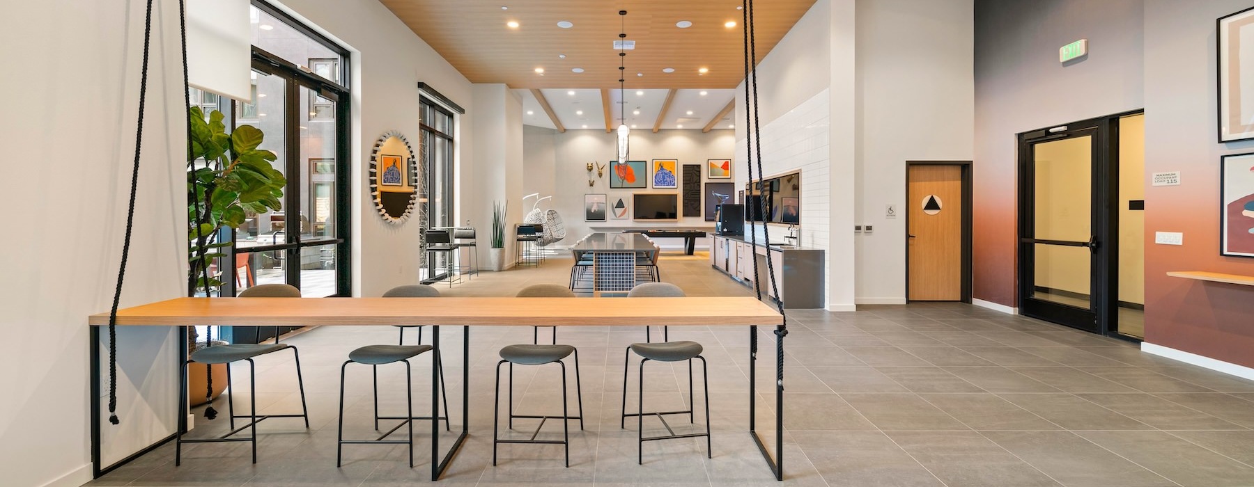 a room with a bar and chairs