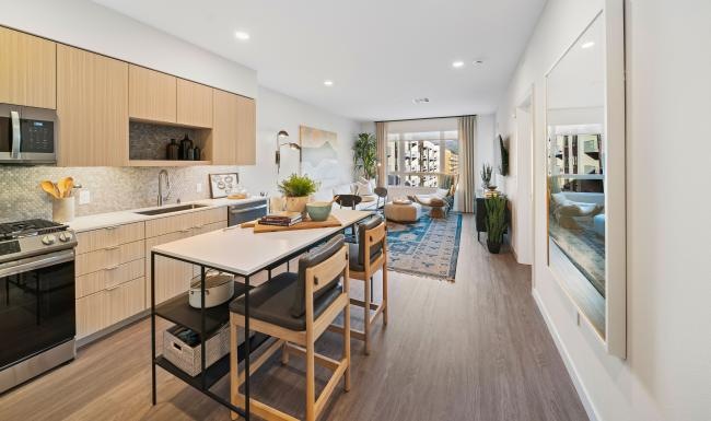 Settle into comfort at Leya a kitchen with wooden cabinets